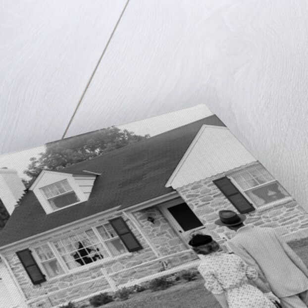 1940s 1950s Couple Standing Outside Looking At Stone Suburban House by Anonymous