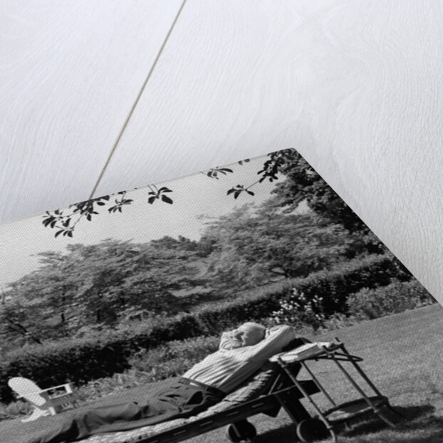1950s Elderly Man In Backyard Stretched Out On Lounge Chair Under Tree by Anonymous
