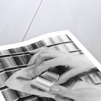 1940s Hand Woman Matching Spool Of Thread To Swatch Of Material by Anonymous