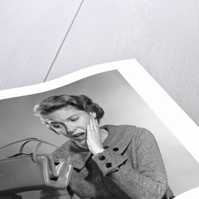 1950s Woman With Exaggerated Expression Hand On Face Looking Inside Her Purse by Anonymous