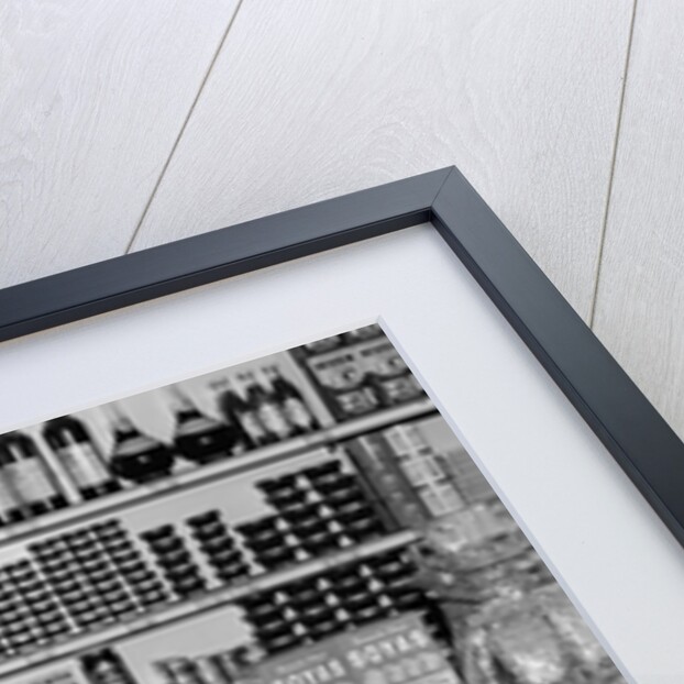 1940s Grocer Standing Behind Counter Filled With Various Food Products by Anonymous