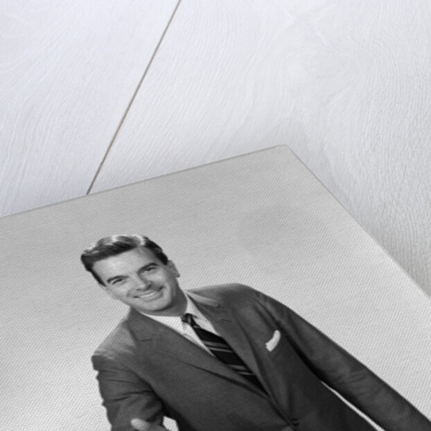 1960s Salesman Or Businessman Leaning Forward Extending Hand For Handshake by Anonymous
