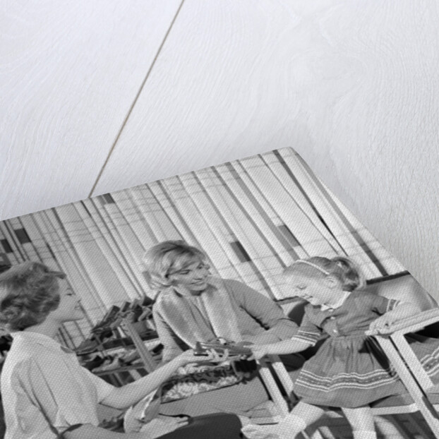 1960s Mother Daughter Shoe Shopping Saleswoman Showing Patent Leather Shoe To Girl by Anonymous