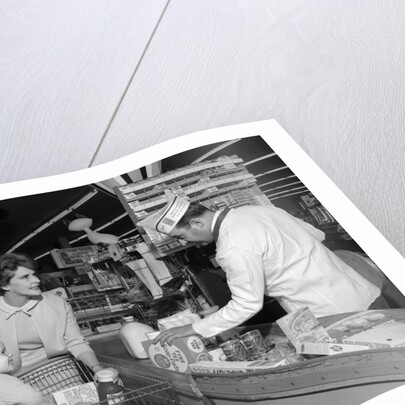 1960s Mother Daughter Unload Grocery Cart At Supermarket Checkout Counter by Anonymous