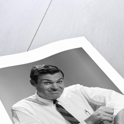 1960s Man In Business Shirt And Tie Rolling Up His Sleeves To Work Determined Look Studio by Anonymous