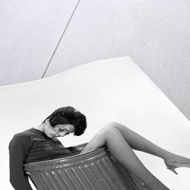 1960s Young Woman In Trash Can by Anonymous