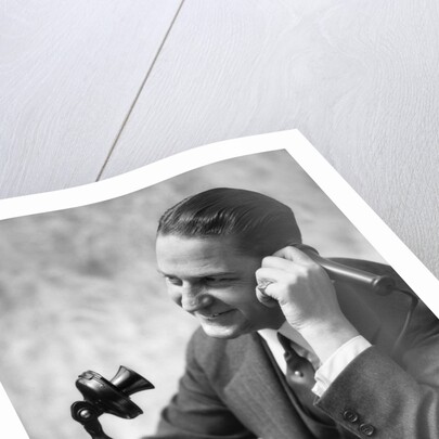 1920s Businessman Talking Into Candlestick Telephone by Anonymous