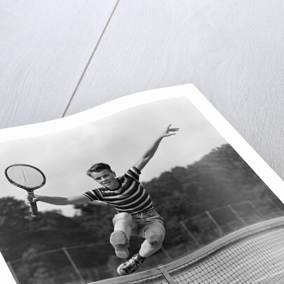 1930s Teenage Boy Tennis Player Jumping Net With Racket In Hand by Anonymous