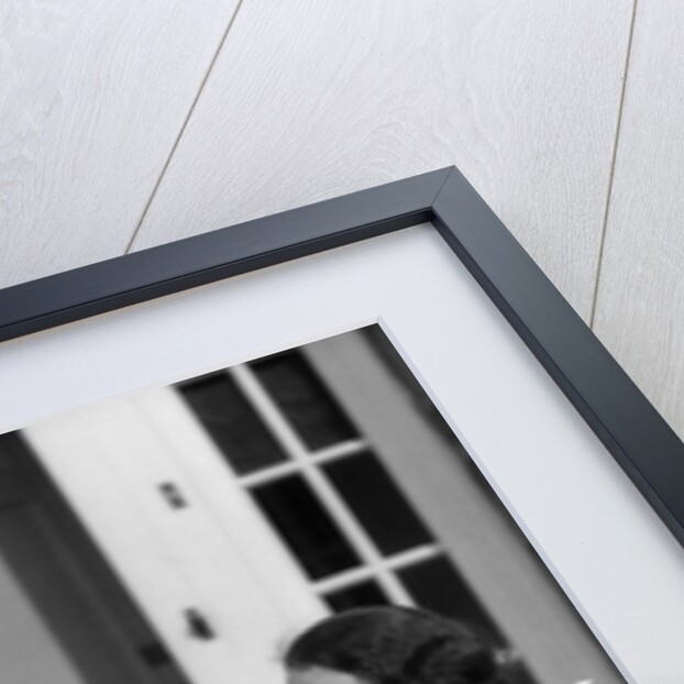 1930s Couple Man Woman In Tennis Whites Holding Racquets Sitting Talking On Steps In Front Of House Outdoor by Anonymous