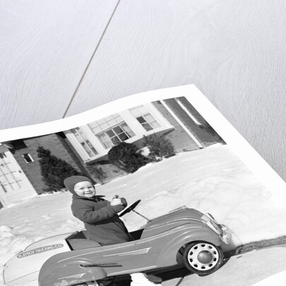 1930s 1940s Little Boy Playing In Toy Car Outside In Snow by Anonymous