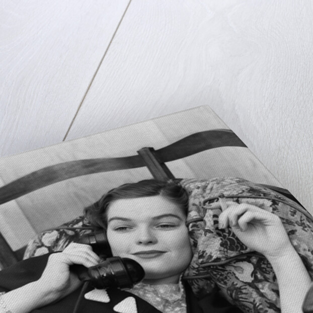 1930s Young Brunette Woman Reclining On Pillows Cigarette In Hand Talking On Telephone by Anonymous