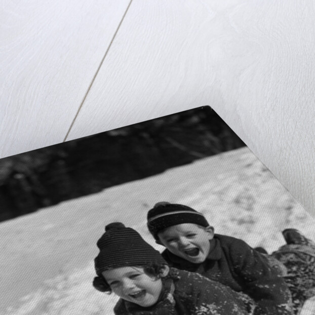 1930 1930s Boy And Girl Laughing Sledding In Snow by Anonymous