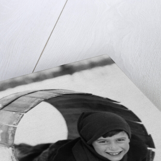 1920s Boy Playing Lying In Snow Rolling In Wooden Barrel by Anonymous