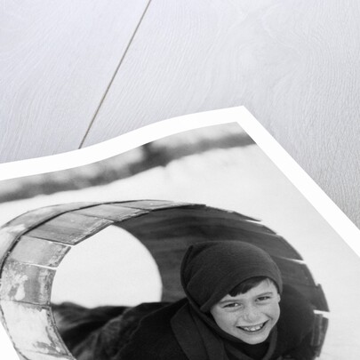 1920s Boy Playing Lying In Snow Rolling In Wooden Barrel by Anonymous