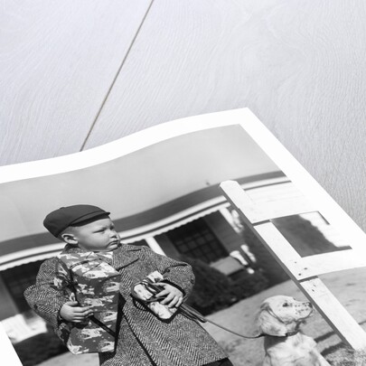 1940s Boy With Puppy On Leash Holding Christmas Present by Anonymous