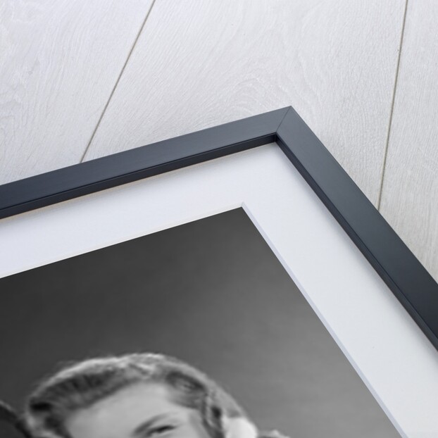 1950s Husband And Wife Carrying Armload Of Christmas Packages Standing In Snow Under Porch Light by Anonymous