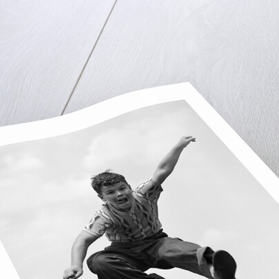 950s Boy Jumping Up by Anonymous