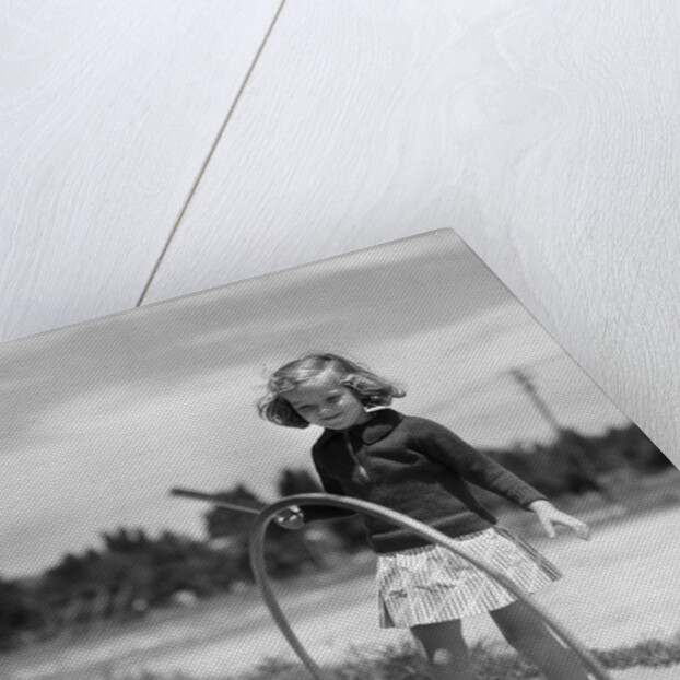 1930s Girl Playing With Hoop And Stick On Sidewalk by Anonymous