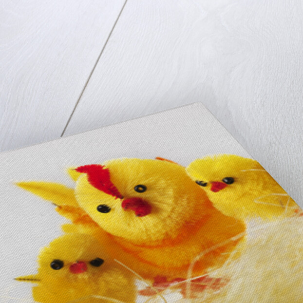 Toy chickens looking at chocolate eggs by Anonymous