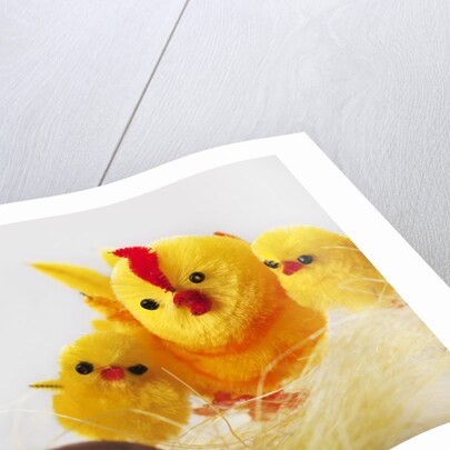 Toy chickens looking at chocolate eggs by Anonymous