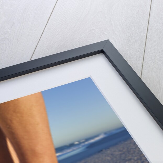 Feet of couple hugging on beach by Anonymous