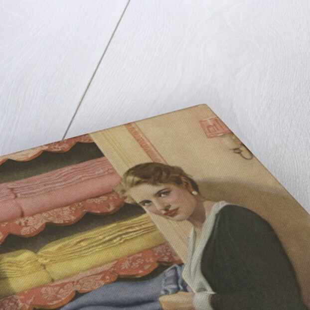 Woman puting away blanket in linen closet by Anonymous