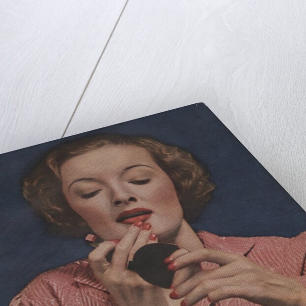 Woman putting on lipstick by Anonymous