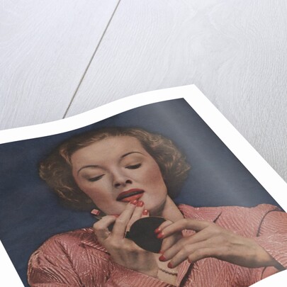 Woman putting on lipstick by Anonymous