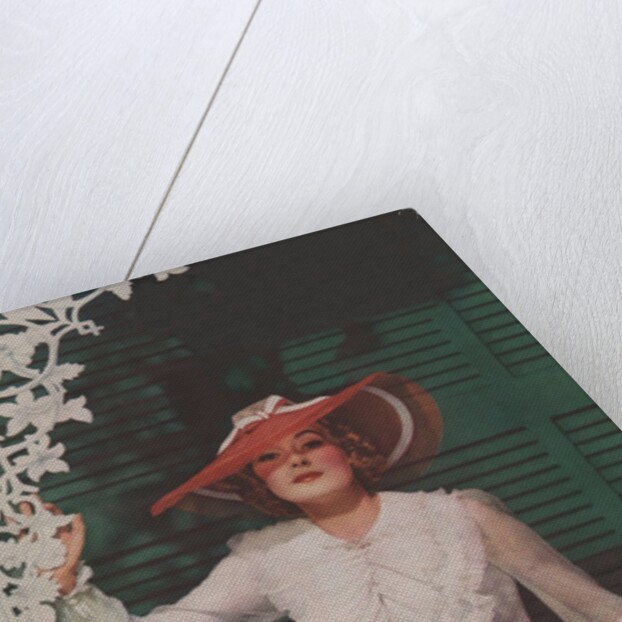 Woman with picture hat on front porch by Anonymous