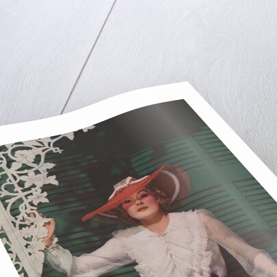 Woman with picture hat on front porch by Anonymous