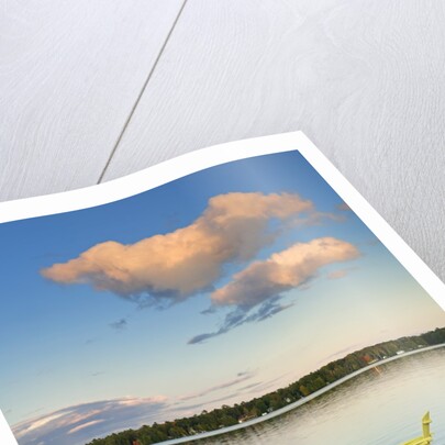 Clouds reflected in Silent Lake with Muskoka chair on dock by Anonymous