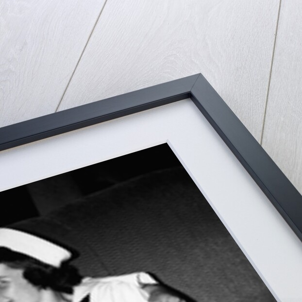 A sailor poses with his"sailor" girlfriend at a party, ca. 1955 by Anonymous