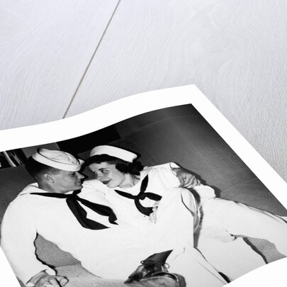 A sailor poses with his"sailor" girlfriend at a party, ca. 1955 by Anonymous