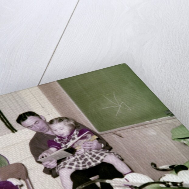 A father reads to his 4 year old daughter, ca. 1957 by Anonymous