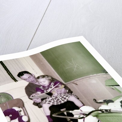 A father reads to his 4 year old daughter, ca. 1957 by Anonymous