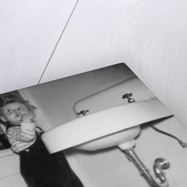 A young girl brushes her teeth at the sink, ca. 1955 by Anonymous