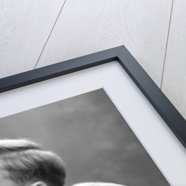 Two brothers look at a candle on a Christmas tree in Germany, ca. 1950 by Anonymous