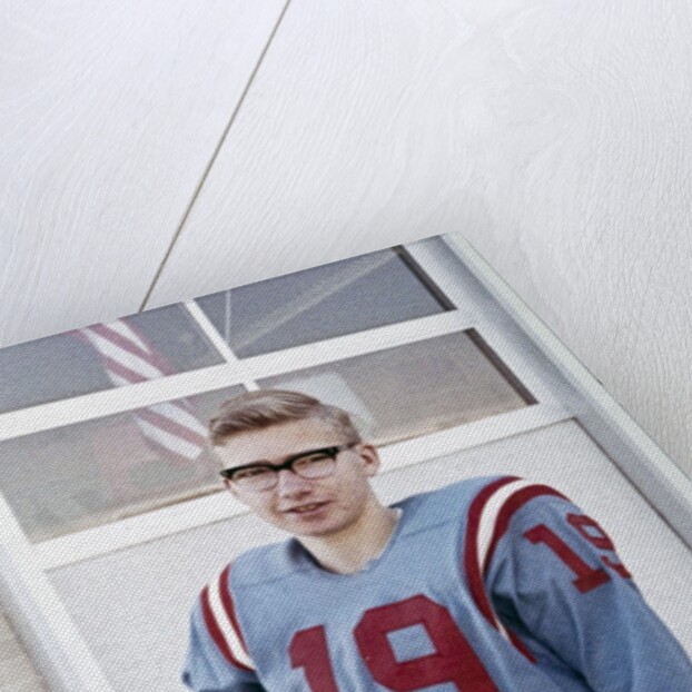 Fifteen year old high school football player portrait outside the school, ca. 1961 by Anonymous