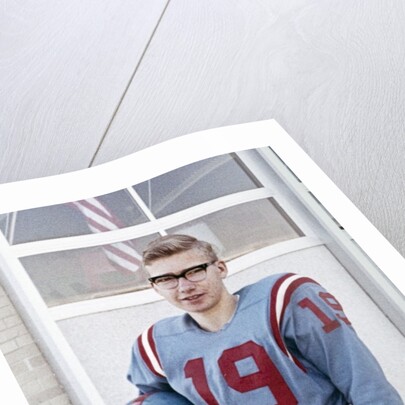 Fifteen year old high school football player portrait outside the school, ca. 1961 by Anonymous