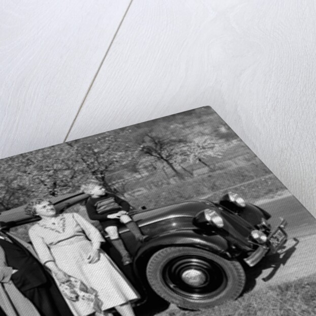 Father and mother stand with their son sitting on the hood of their Mercedes automobile, ca. 1950 by Anonymous