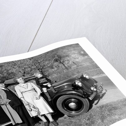 Father and mother stand with their son sitting on the hood of their Mercedes automobile, ca. 1950 by Anonymous