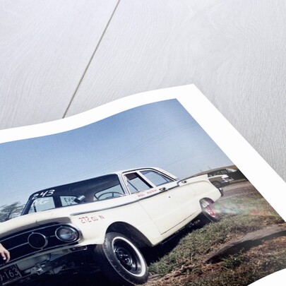 Sixteen year old boy stands with his 1960 Mercury Comet automobile, ca. 1962 by Anonymous