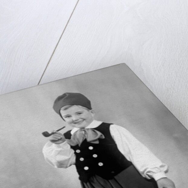 Six year old boy in Bavarian costume holds a pipe, ca. 1947 by Anonymous