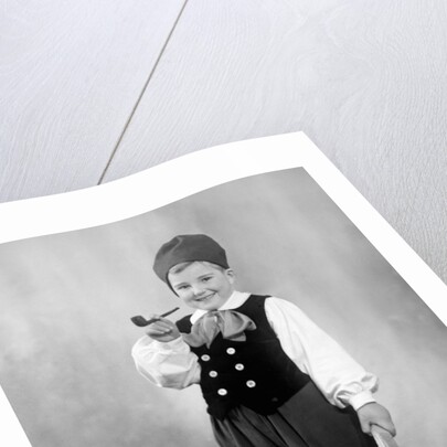 Six year old boy in Bavarian costume holds a pipe, ca. 1947 by Anonymous