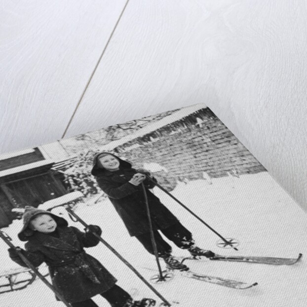 Two brothers stand on their skis in the snow, ca. 1950 by Anonymous