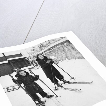 Two brothers stand on their skis in the snow, ca. 1950 by Anonymous