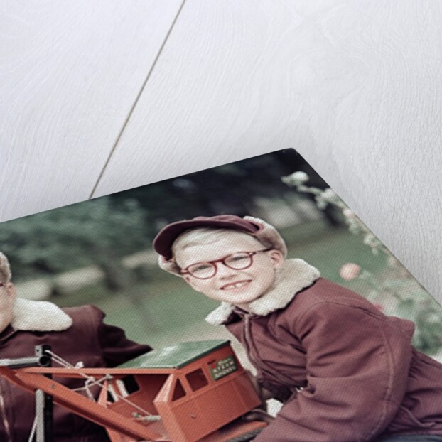 Two brothers play with a Buddy L steam shovel toy in Wisconsin, ca. 1953 by Anonymous