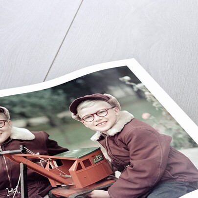 Two brothers play with a Buddy L steam shovel toy in Wisconsin, ca. 1953 by Anonymous