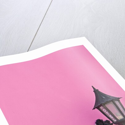 Street lamp on pink wall of Colonial style building by Anonymous