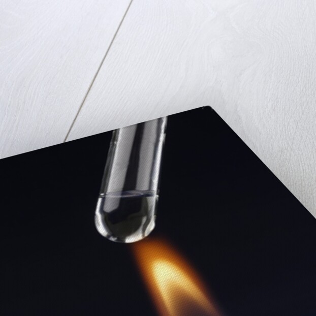 Test tube with liquid, over flame by Anonymous